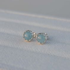 These sterling silver stud earrings feature 6mm round Aquamarine stones set in a fancy bezel.  ★ All orders come wrapped in a gift box, ready for gifting ★ Aquamarine Earrings, Aquamarine Stone, Sterling Silver Studs, Sterling Silver Earrings Studs, Silver Studs, Stone Settings, Silver Earrings Studs, Aquamarine, Post Earrings