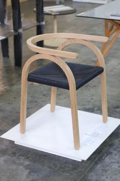 a wooden chair sitting on top of a white platform