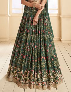 COLOR : Dark Green FABRIC : Top (Blouse) - Pure Georgette, Bottom (Lehenga) - Pure Georgette, Inner - Cancan, Dupatta - Chinon WORK : Thread Work, Beads, Stones, Sequins, Digital Print, Lace Border OCCASION : Wedding, Reception, Sangeet, Engagement READY-TO-WEAR : NoSTITCHING : Available as semi-stitched fabric, can be stitched using standard size option (+$30). Note: There might be a slight color variation due to lighting and flash used during photoshoot. The bright shade seen is the best close Floral Print Floor-length Sharara For Wedding, Fitted Green Lehenga With Floral Print, Green Floor-length Set With Floral Embroidery, Green Floor-length Sets With Floral Embroidery, Green Floral Embroidery Floor-length Dress Set, Green Floral Embroidery Floor-length Sets, Bollywood Style Floral Print Wedding Gown, Bollywood Style Floral Wedding Gown, Bollywood Wedding Gown With Floral Print