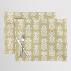 two place mats with pineapples on them