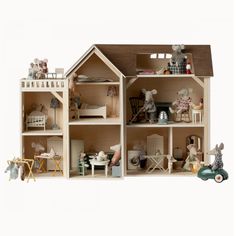 a doll house with furniture and accessories on the inside, as well as an animal figurine