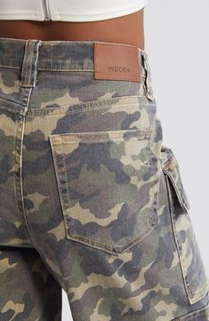 Channel laid-back skater style with these baggy denim shorts featuring camo print, a plethora of cargo pockets and raw hems for a lived-in look. 12" inseam; 12" rise Zip fly with button closure Five-pocket style; cargo flap-patch pockets 94% cotton, 5% polyester, 1% spandex Machine wash, tumble dry Imported Camo Aesthetic, Baggy Denim Shorts, Denim Cargo Shorts, Clothes Wishlist, Camouflage Pants, Womens Camo, Camo Cargo Pants, Denim Cargo, Baggy Denim