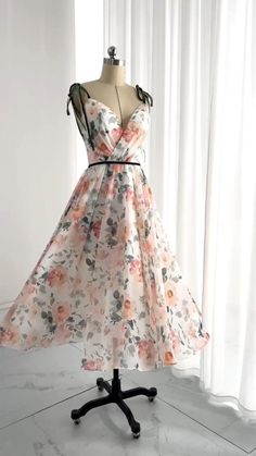 a dress on a mannequin in front of a window