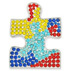 a colorful puzzle piece with lots of different colored dots on the bottom and one side