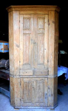 an old wooden armoire sitting in the middle of a room