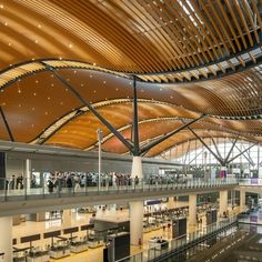 the inside of an airport with people walking around