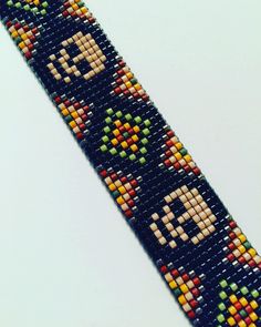 a beaded bracelet with an old video game character on it