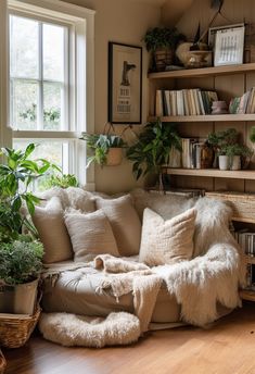 a living room filled with lots of plants and bookshelves next to a window