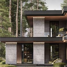 a modern house in the woods surrounded by trees