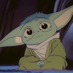 the child yoda from star wars is sitting down