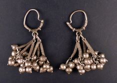 Nice and very old genuine ethnic and tribal earrings from Himachal Pradesh (India) and made with high-grade silver. It's made with a ring from which several dangles hang graciously, and made a nice sound when moving. These ethnic earrings measure approx. 9 cm high (3,54 in) and they both weight 85 gr. The gauge of the silver wire is 2 mm. IND489 They are from the end of the XIX century or the beginning of the XXth, and they come from a European collection. If sold outside the EU, the buyer is re Silver Indian Jewelry, Macrame Earrings, Jewelry Indian, Ethnic Earrings, Himachal Pradesh, Ethnic Jewelry, Gold Jewelry Fashion, Earrings Silver, Silver Wire