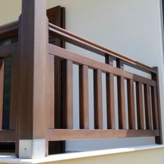 a wooden balcony railing on the side of a house