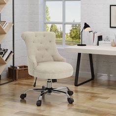 a white desk chair sitting in front of a window next to a book shelf and bookshelf