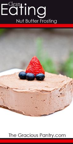 a close up of a piece of cake with chocolate frosting and strawberries on top