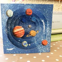 a card with planets on it sitting on a table