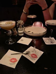 a table topped with glasses filled with different types of drinks