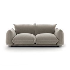 a grey couch with two pillows on it's back and one arm facing the camera