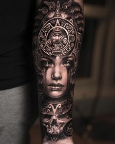 a woman's arm with tattoos on it and an intricate design in the middle