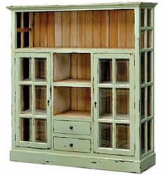 an old green bookcase with glass doors on the front and bottom, is shown