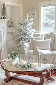 a living room filled with furniture and a white christmas tree in the middle of it