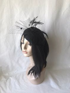 HatsByJosie: This black feathered fascinator hat is ideal for wedding, mother of the bride, women church hat, Kentucky Derby hat, tea Party hat or any other special occasion. Easy to wear Can be worn on both sides Floaty feathers Dotted floaty veil Free standard shipping Shipping upgrades available: Priority shipping 2-3 business days Express shipping 1-2 business days Love what you see would like a different color? Please feel free to send a message we'd love to create a hat for you. Looking fo Black Gatsby Fascinator For Parties, Gatsby Style Black Fascinator For Parties, Black Gatsby Style Fascinator For Party, Black Gatsby Fascinator For Evening, Black Gatsby Style Fascinator For Evening, Black Gatsby Style Party Fascinator, Black Hat-style Headpieces For Wedding, Black Hat Headpiece For Wedding, Black Hat Style Headpieces For Wedding