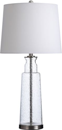 a glass table lamp with a white shade on the base and a silver metal base