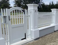 a white fence with two gates on each side