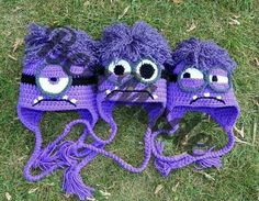 two purple hats with googly eyes on them