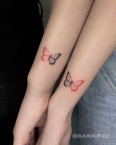 two butterflies on their arms are shown with red ink and one is black, while the other