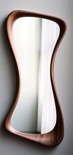 a curved mirror mounted to the side of a wall