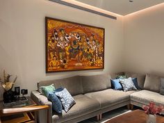 a living room filled with furniture and a painting on the wall above it's couch