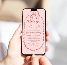 a person holding an iphone with a christmas party card on it