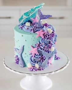 there is a cake decorated with purple and blue decorations