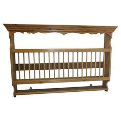 a wooden bed frame with an attached shelf on the top and bottom, against a white background