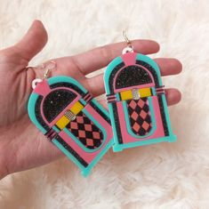 "These rad af Jukebox Earrings are super colorful, and are an awesome statement piece for any outfit! *These earrings can be made as hooks, regular posts, or wrap around hooks -- if you prefer any of these options just let us know in the notes to seller section during checkout! *They were designed digitally by BC, then laser cut with many colors of 1/8 of an inch thick acrylic. *The pendants were attached to a lightweight layer of 1/16\" black acrylic for extra durability while remaining lightwe Retro Dangle Earrings For Gift, Retro Dangle Earrings Gift, Retro Multicolor Earrings With Ear Wire, Retro Handmade Earrings For Party, Handmade Retro Earrings For Party, Retro Adjustable Pink Earrings, Handmade Retro Party Earrings, Retro Dangle Earrings, Retro Rectangular Earrings For Gift