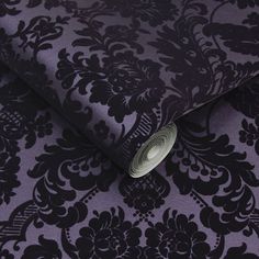 a purple and black wallpaper with an intricate design on it's surface,