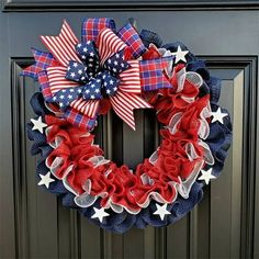 a patriotic wreath with red, white and blue stars on it is hanging on the front door