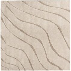 a beige rug with wavy lines on the top and bottom, in front of a white background