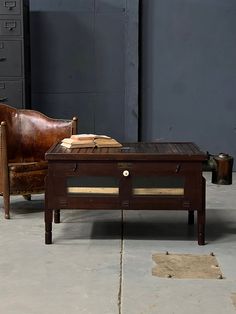 an old leather chair sitting next to a coffee table