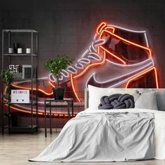 a room with a bed and a neon nike shoe on the wall