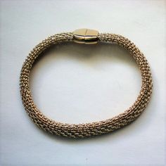 This fabulous woven chain bracelet is signed Monet and looks as if it is pure 18K gold.  The piece is 7½ inches in length and ¼ inch wide with a hidden magnetic clasp.  It is in excellent condition and looks as if it has never been worn. Thanks for looking and visiting my shop.  Please view the shop often as I regularly add new and interesting items and offers are always considered. Gold Metal Braided Bracelets, Gold Braided Bracelet With Lobster Clasp As Gift, Metal Link Bracelets With Gold Clasp, Gold Snake Chain Bracelet With Lobster Clasp, Gold Metal Braided Bracelet, Adjustable Gold Braided Bracelets For Formal Occasions, Everyday Handmade Gold Chain Bracelet, Formal Gold Braided Jubilee Bracelet, Formal Gold Braided Jubilee Style Bracelet