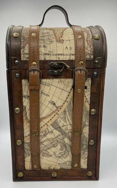 an old world map suitcase with leather straps