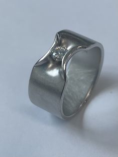 a silver ring with a diamond in the center