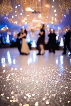 the dance floor is covered in white and silver confetti