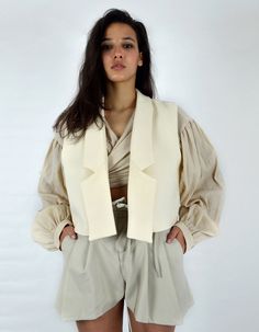 Made in France.Product Description- Short sleeveless jacket,- Beige cotton canvas,- Unstructured glue,- Fully lined, The MUSKEG Jacket is a variation of the DOLMA coat that you love. Designed in beige cotton canvas, the MUSKEG jacket retains the pure, graphic lines of the Louise Marcaud brand while offering the possibility of layering. Over a shirt, sweater or coat. The idea is to play with the codes of layering. Its short cut, and its light material, are ideal for creating sophisticated and rel Mini Jacket, Sleeveless Jacket, Slow Fashion, Summer Looks, Made In France, Women's Blazer, Cotton Canvas, Glue, Layering