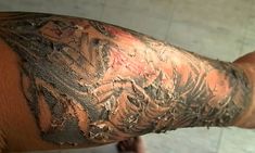 the arm is covered in black and white ink with red spots on it's skin