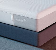 two mattresses stacked on top of each other with the word wave printed on them