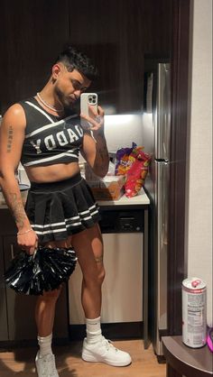 a man in a cheerleader outfit taking a selfie