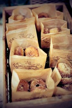 donuts in brown paper bags sitting on top of each other