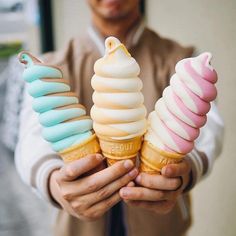 a man holding three ice cream cones in his hands